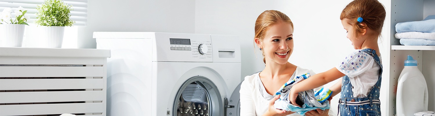 Mother and daughter in laundry room