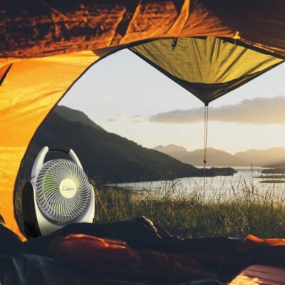 inside a camping tent looking outdoors at scenery and Lasko Battery Fan model RB200